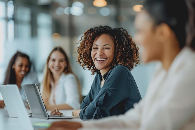 Happy businessman laughing while working together in the office with a group of new business people