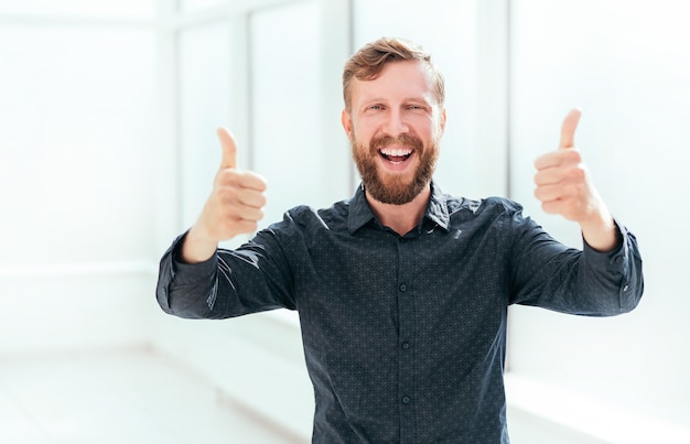 Happy businessman showing thumbs up. photo with copy space