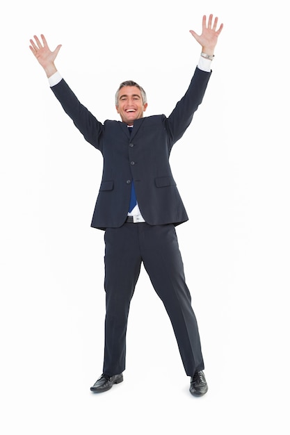 Happy businessman in suit with arms up