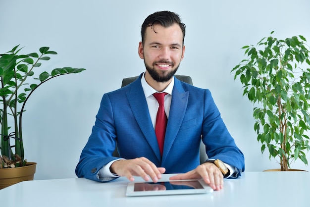 Happy businessman using digital tablet computer