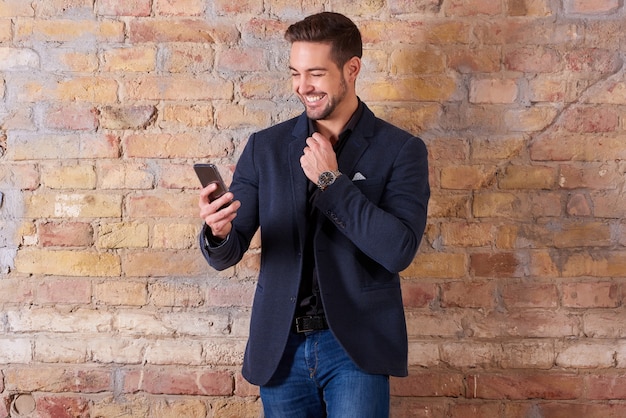 Happy businessman using smartphone