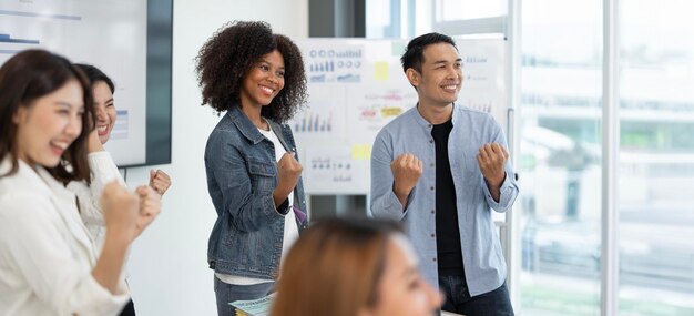 Happy businesspeople laughing while collaborating on a new project in an office Group of diverse businesspeople working together