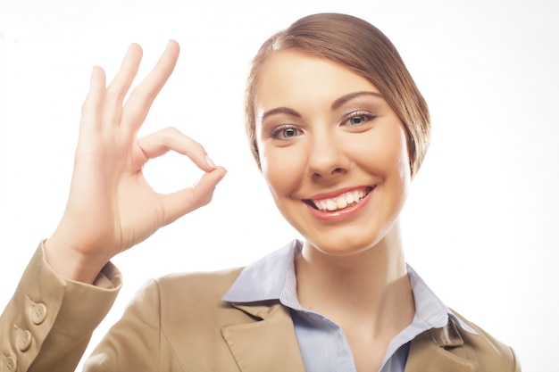 Happy businesswoman making an ok sign