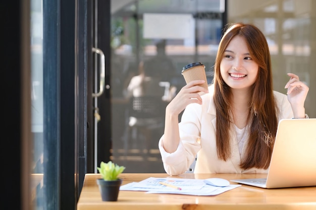 Happy businesswoman relaxing at office desk