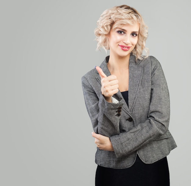 Happy businesswoman showing thumb up