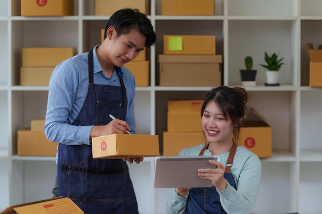 Happy bussiness Startup small business with parcel box for deliver to customer and working together at home