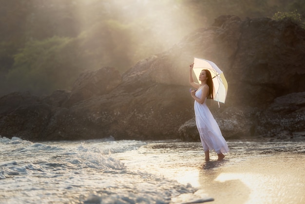 Happy Carefree Woman Enjoying Beautiful Sunset on the Beach