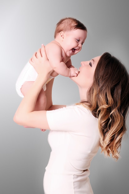 Happy caring mother and her cute baby girl