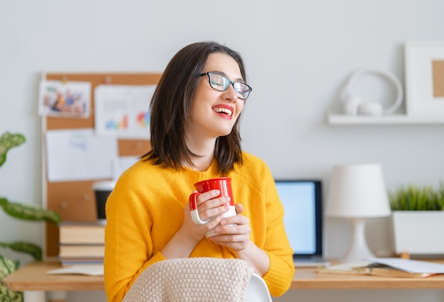 Happy casual beautiful woman working in home office.