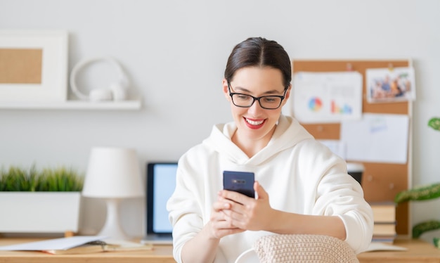 Happy casual beautiful woman working in home office.