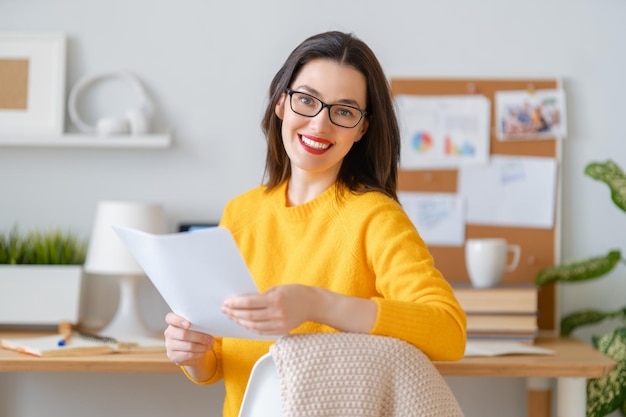 Happy casual beautiful woman working in home office.