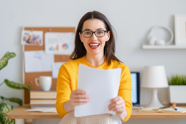 Happy casual beautiful woman working in home office.