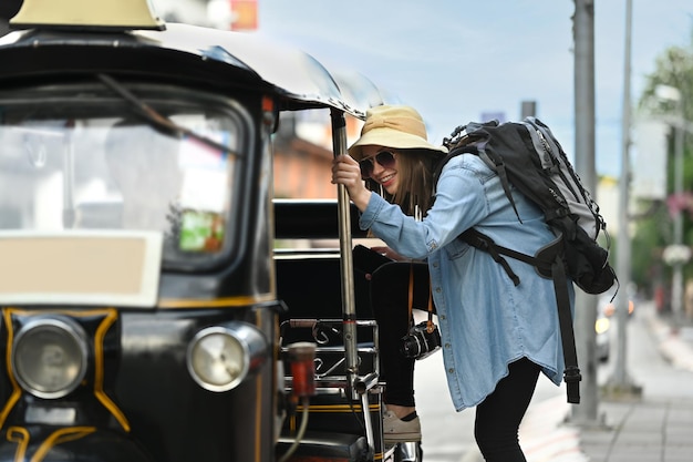 Happy caucasian female traveler with backpack on holiday vacation trip in Thailand Blogger vacation and journey concept