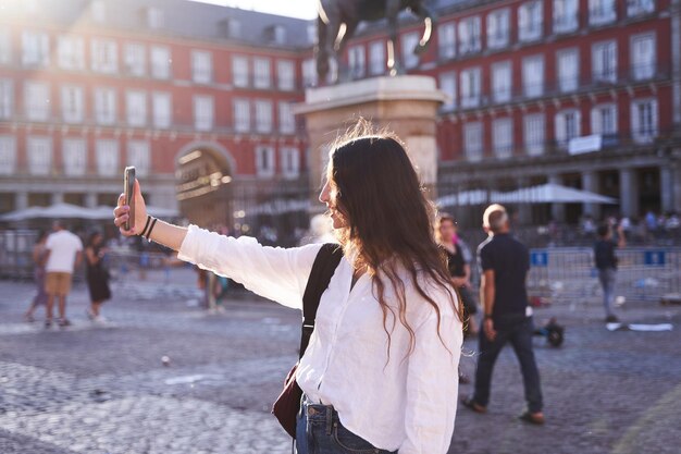 Happy caucasian woman is taking a selfie