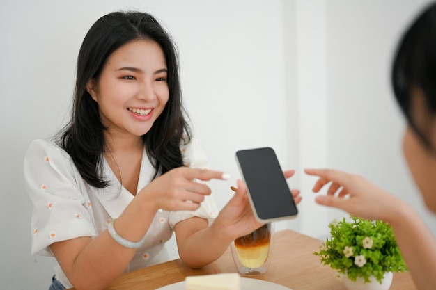 Happy and cheerful Asian young woman enjoy talking chatting with her friends in the cafe coffee shop