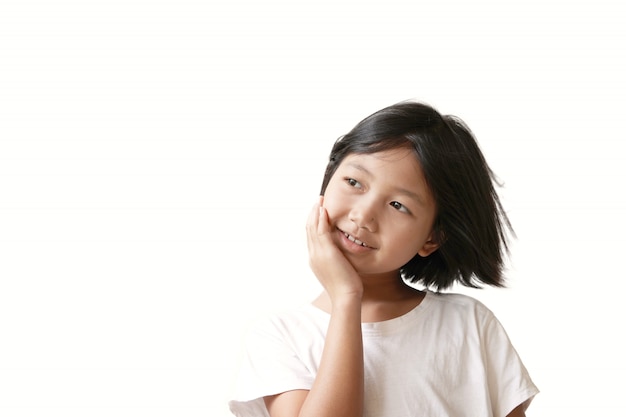  Happy cheerful little girl on white wall with soft light display in fresh morning time                          