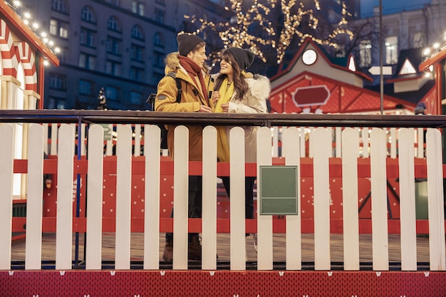 Happy cheerful and young caucasian couple are having fun while dating together outdoors in a city