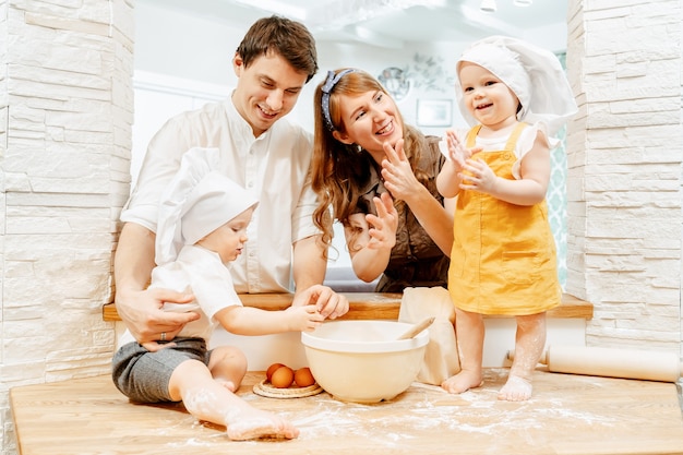 Happy cheerful young caucasian family mom dad and twins boy