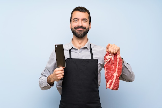 Happy Chef holding a raw meat