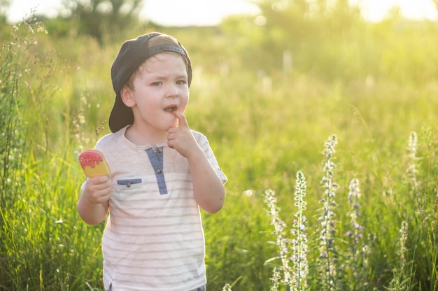 Happy child eating cookies in the form of ice cream