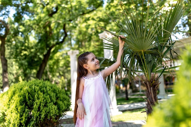 Happy child enjoying the beautiful nature in the park Summer time and vacations