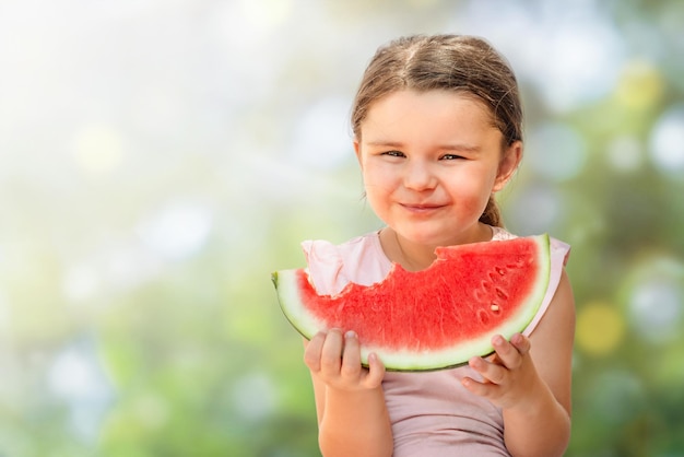 Happy child girl with watermelon bite isolated