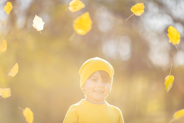 Happy child having fun outdoor in autumn park