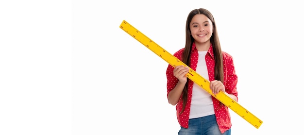 Photo happy child hold ruler study mathematics at school isolated on white back to school banner of schoolgirl student school child pupil portrait with copy space