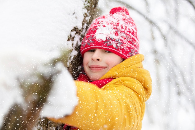 Happy child is having fun and playing in winter