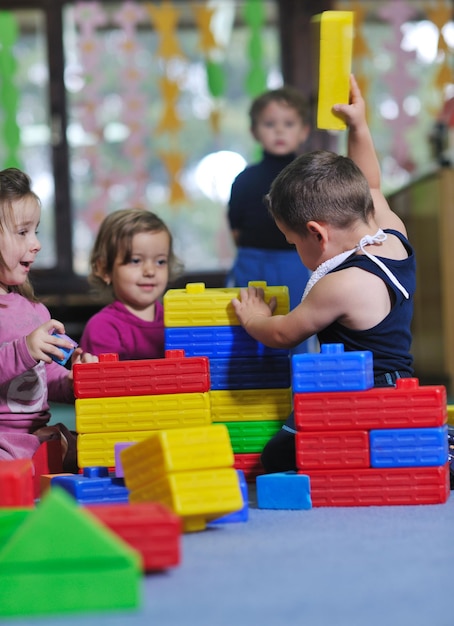 happy child kids group have fun and play at kindergarden indoor preschool education concept with  teacher