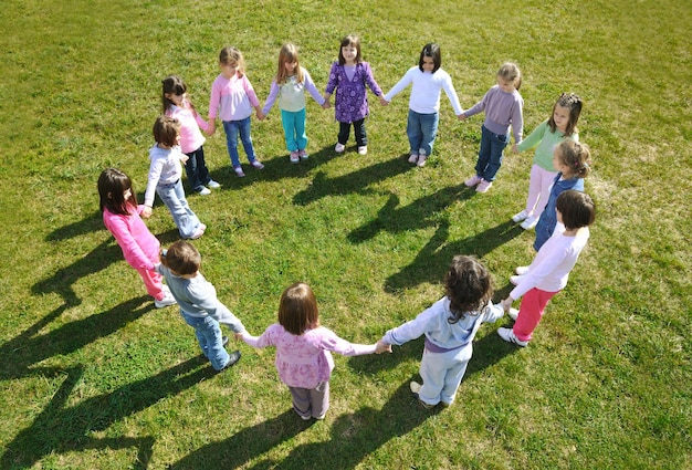 happy child kids group have fun and play at kindergarden outdoor preschool education concept with  teacher