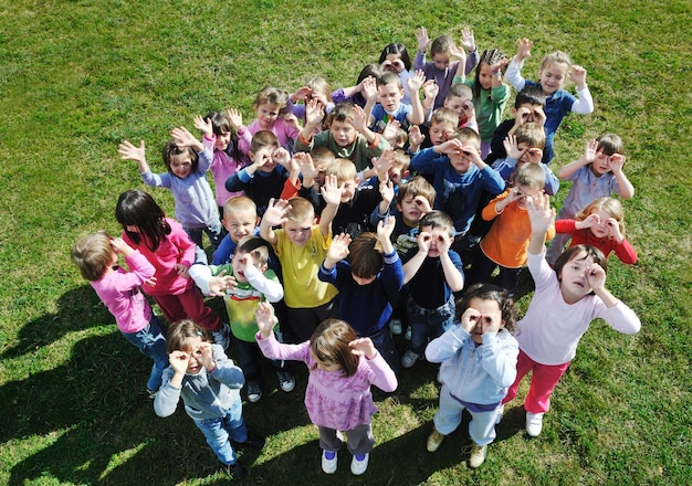 happy child kids group have fun and play at kindergarden outdoor preschool education concept with  teacher