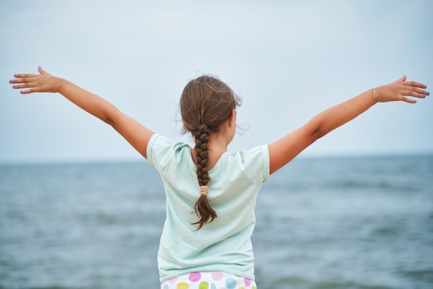 Happy child looking at the sea