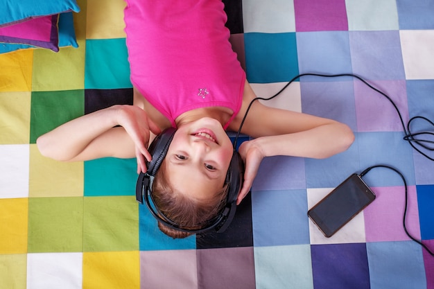 Happy Child lying and listening to music.  childhood and music.