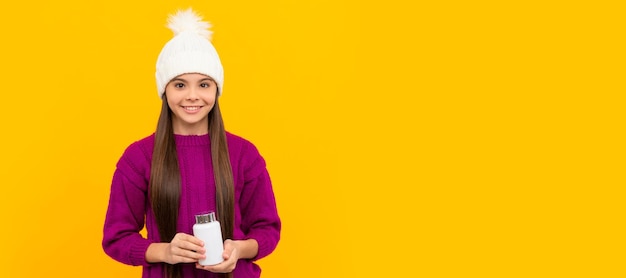 Happy child in winter hat with pill jar health Horizontal poster isolated child face banner header