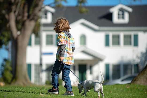 Happy child with dog kid boy with pet