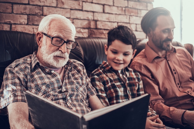 Happy Child with Father and Grandfather in Barbershop