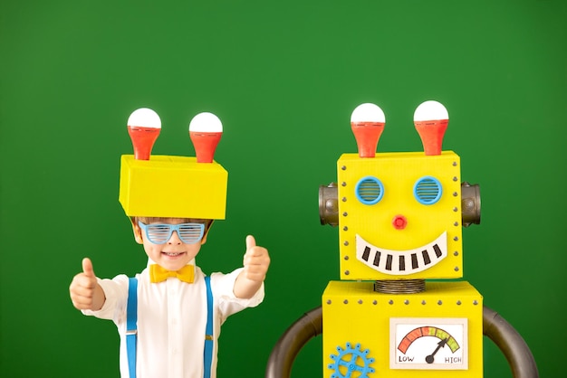 Happy child with toy robot in class