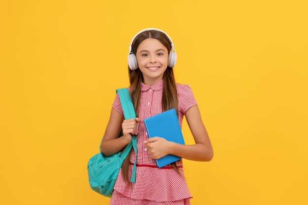 Happy childhood child with school bag music happy teen girl carry backpack back to school