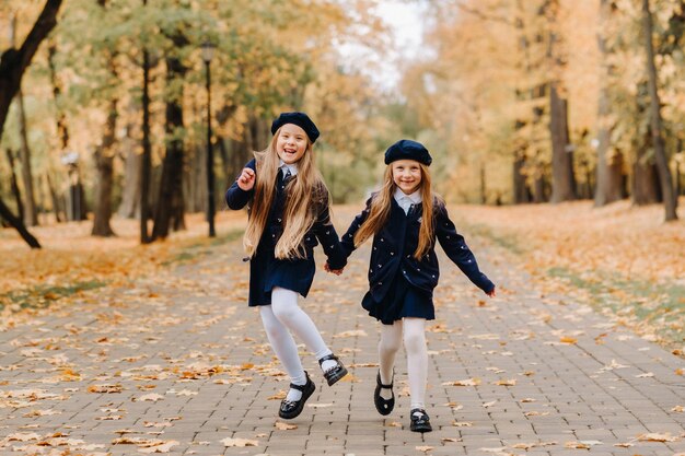 Happy children are running in a beautiful autumn park