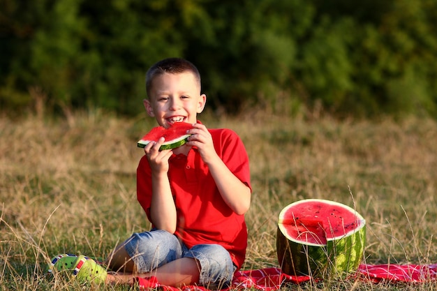 happy children eat watermelon on summertime