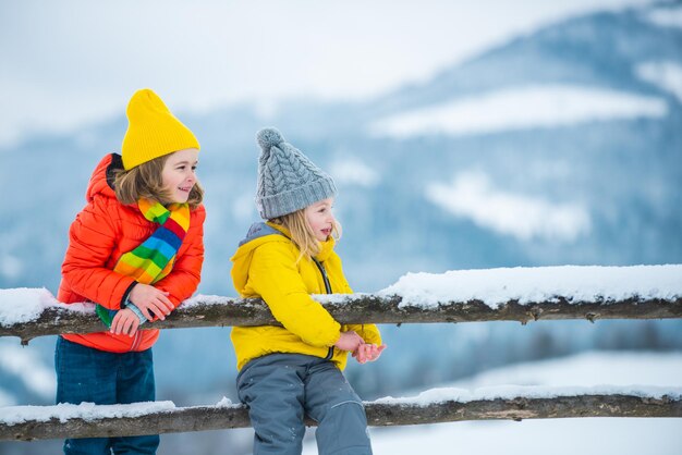 Happy children friends in snow. Little girl and boy having fun at winter day.