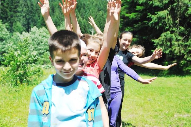 happy children group  have fun outdoor in nature at suny day