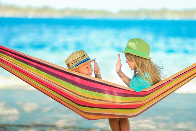 A Happy children on a hammock by the sea in nature travel vacation on vacation