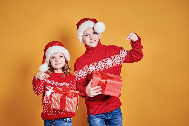 Happy children holding red gift boxes