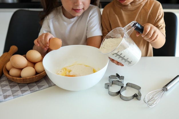 Happy children in the kitchen make cookies Cooking master class