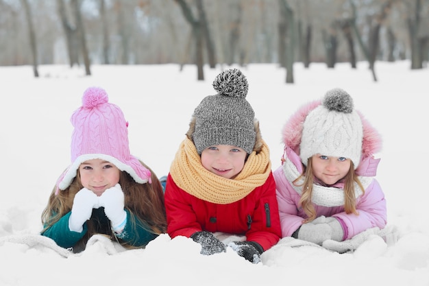 Happy children lying on snow