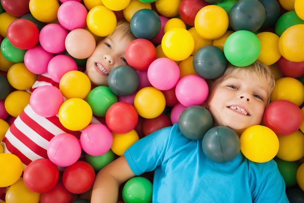 Happy children playing in ball pool 