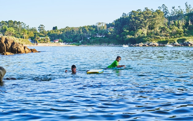 Happy children playing in the sea. Children having fun outdoors. Concept of summer vacation and healthy lifestyle.