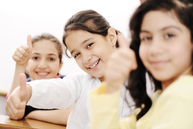 Happy children smiling and laughing in the classroom